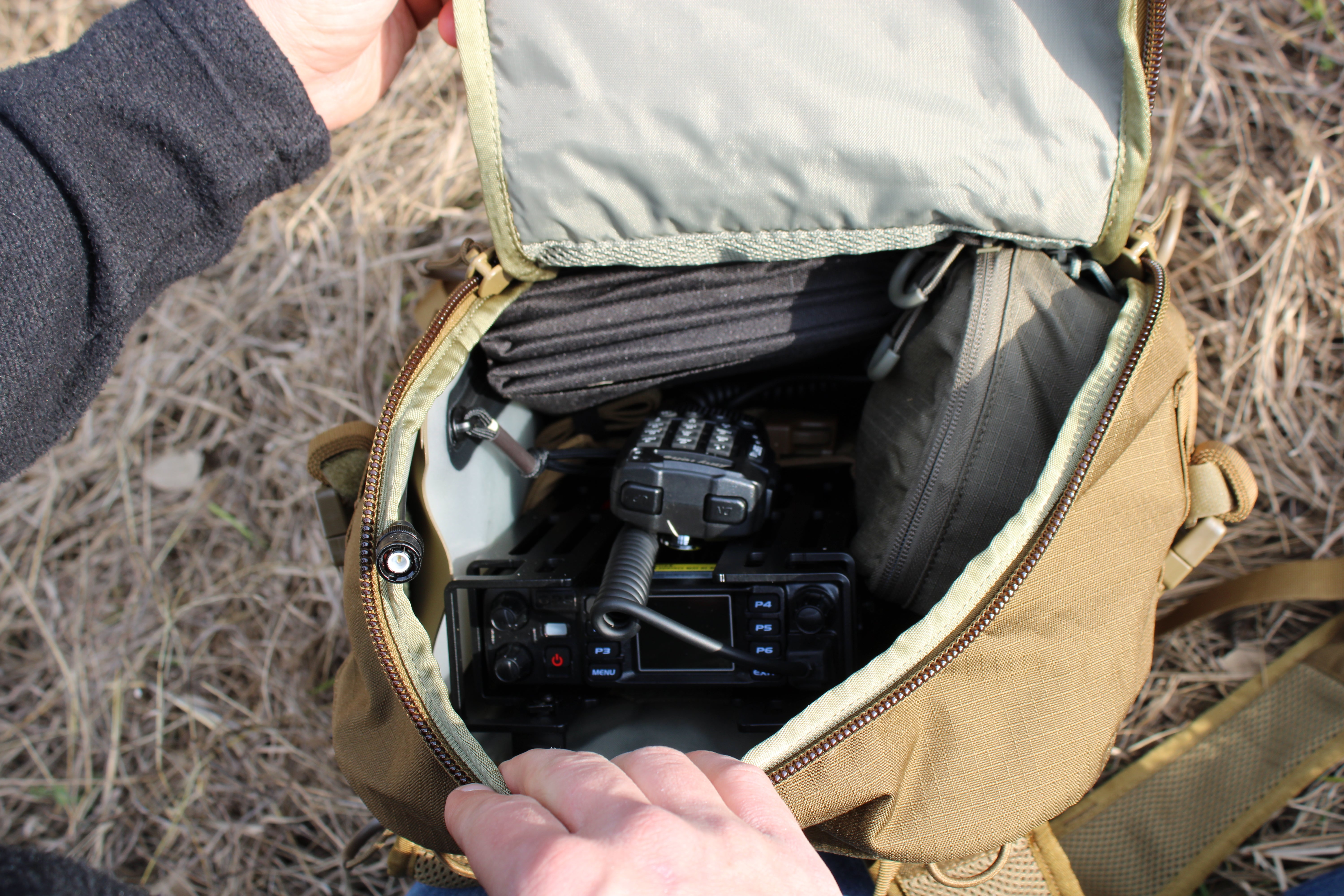 UHF/VHF Emergency Radio Kit with mobile and handheld radios, solar panel, lithium batteries, and Eberlestock Mission Assault Pack