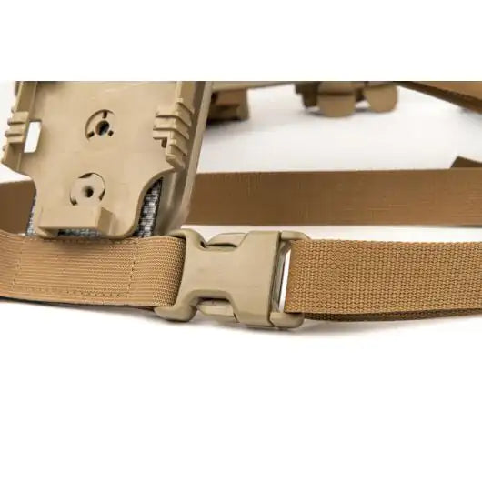 Detail view of leg strap mounted between holster adapter and belt system